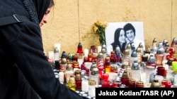 People light candles in tribute to murdered Slovak investigative reporter Jan Kuciak, 27, and his fiancee, Martina, 27, in Bratislava on February 27.