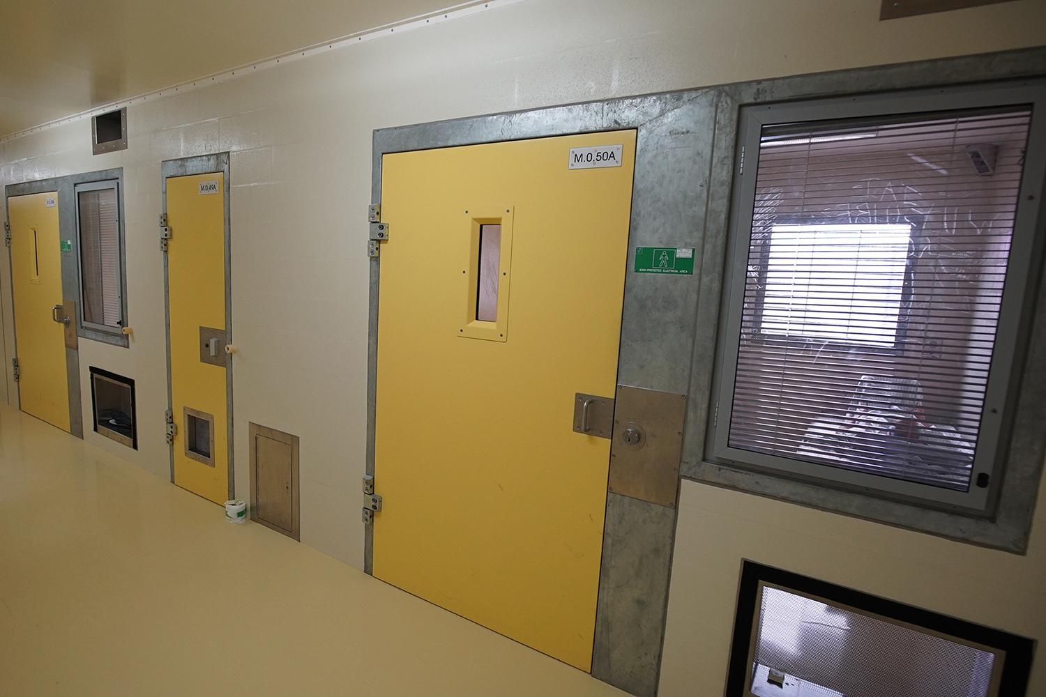 A prisoner lies in his solitary confinement cell in the safety unit at Lotus Glen Correctional Centre, northern Queensland. Prisoners in solitary confinement typically spend 22 hours or more a day locked in small cells, sealed with solid doors, without meaningful social interaction with other prisoners; most contact with prison and health staff is perfunctory and may be wordless.