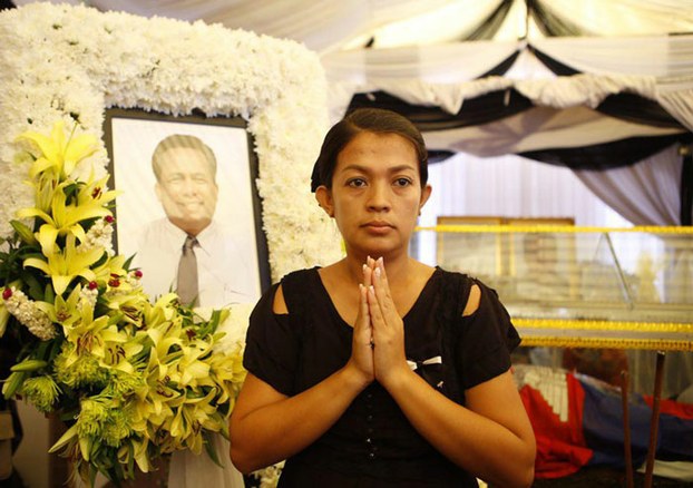 Bou Rachana stands in front of an image of slain husband Kem Ley.