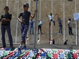 Libyan men stand during a protest after Friday prayers in Green Square, downtown Tripoli