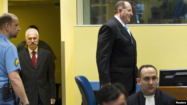 Former high ranking Bosnian Serb officials Mico Stanisic (right) and Stojan Zupljanin (left) arrive at the courtroom to attend trial at the International Criminal Tribunal for the former Yugoslavia in The Hague on March 27.