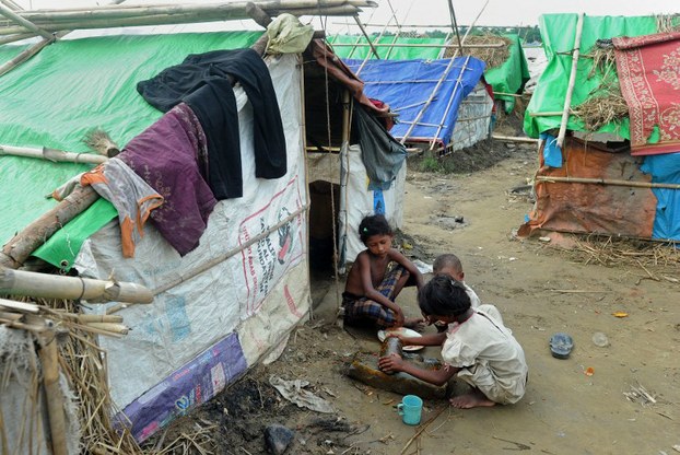 Rohingya children prepare a meal at a camp for internally displaced people on the outskirts of Sittwe, May 17, 2013.