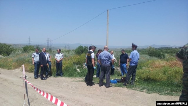 Investigators work at the site where Russian serviceman Ivan Novikov was killed in Gyumri, on June 15. 