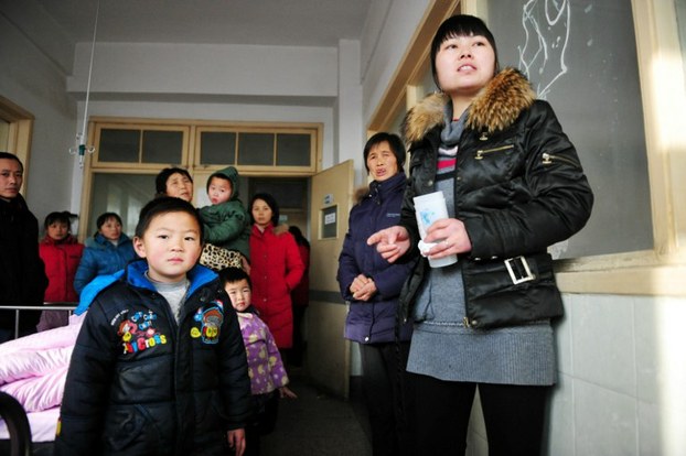 Chinese parents stand next to their children suffering from lead poisoning at a hospital in Anhui province, Jan. 6, 2011.