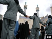 Policewomen form a human chain to keep the rival protests apart.