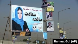 Campaign posters for Afghanistan's upcoming parliamentary elections are displayed on a Kabul street on September 28.