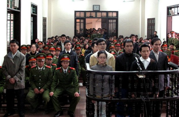 Activists convicted of plotting to 'overthrow' the government listen to their verdicts at a court in Vinh, Nghe An province on Jan. 9, 2013.