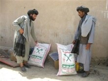 Afghanistan - Afghan men recieve food rations from the World Food Program (WFP) during a distribution programme in Helmand province, 14May2007