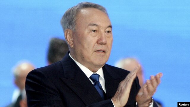 Kazakh President and presidential candidate Nursultan Nazarbaev applauds as he attends a session of the Assembly of People of Kazakhstan in Astana on April 23.