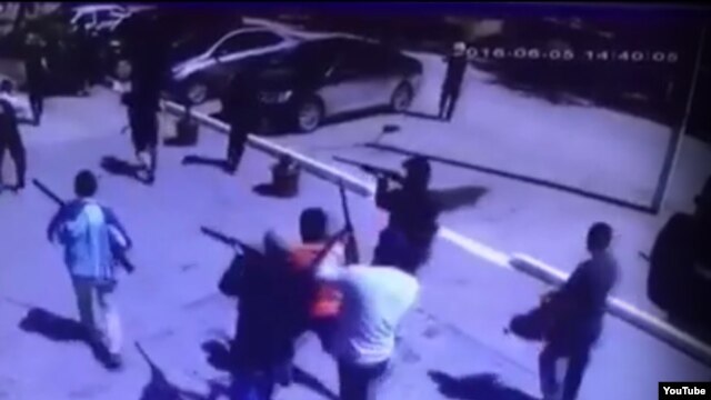 A screen grab of a YouTube video showing masked gunmen on the streets of Aqtobe after the attacks.