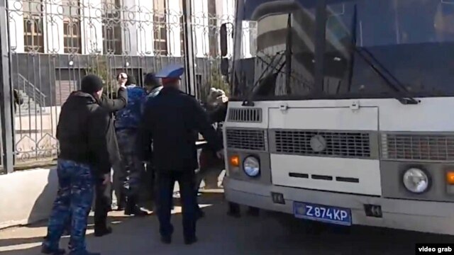 Kazakh police detain protesters against the confiscation of their land by the state in Astana on April 15.