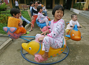 HIV-positive children play at a kindergarten in Hatay, near Hanoi, Vietnam, March 21, 2006.