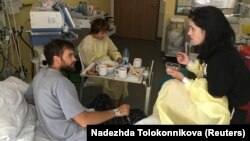 Pyotr Verzilov (left) speaks with ex-wife Nadezhda Tolokonnikova in his Berlin hospital room, where he was recovering from suspected poisoning.