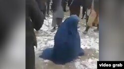 A video shows a mob beating an Afghan woman in Tarkhan Province because she allegedly had an extramarital affair.