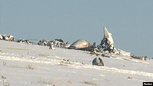 The remains of an Antonov An-72 military transport plane after it crashed near Shymkent in December 2012 – Asqar Buldeshev was charged with fraudulent activities related to the repair of air force equipment.
