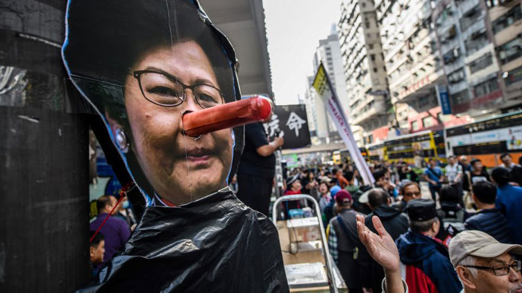 Protesters angry at what they described as suppression by Beijing mock Hong Kong's Chief Executive Carrie Lam in the annual New Year's Day pro-democracy rally in the Chinese city, Jan. 1, 2018.