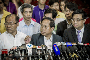 Democratic Party leader Albert Ho (C) speaks to reporters in Hong Kong, Sept. 10, 2012.