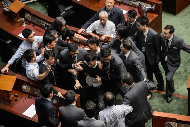 Newly elected lawmaker Sixtus Leung (C) is restrained by security after attempting to read out his Legislative Council oath at Legco in Hong Kong on Nov. 2, 2016.