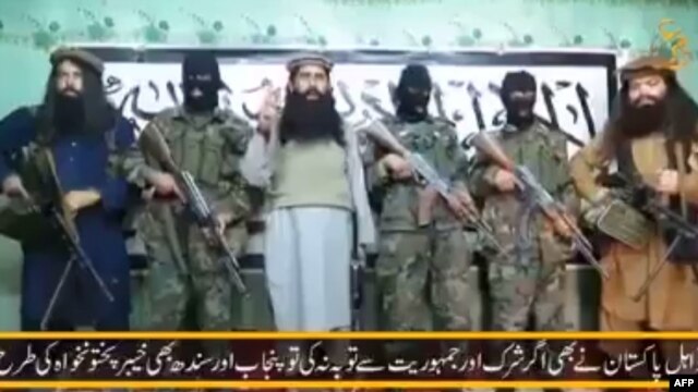 A video released by a faction within the Pakistani Taliban on January 22 shows their leader, Umar Mansoor (center), with militants delivering a statement from an undisclosed location.