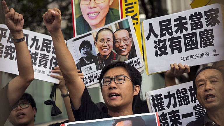 Raphael Wong (C), deputy head of the pan-democratic League of Social Democrats party, chants slogans during a protest on China's National Day of celebrations in Hong Kong, Oct. 1, 2016.