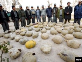 Police inspect piles of heroin discovered during an operation in Herat, Afghanistan