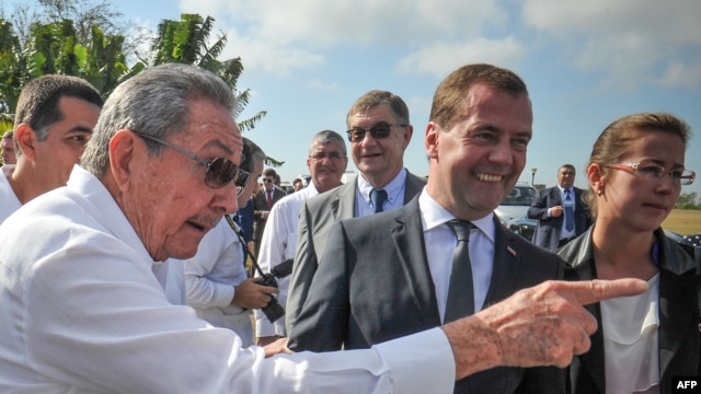 Cuban President Raul Castro (left) and Russian Prime Minister Dmitry Medvedev talk to journalists after a visit to the Soviet Soldier Monument in Havana on February 22.