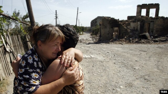 Two women hug each other amid ruins in the South Ossetian capital of Tskhinvali, which was devastated by the brief Georgian-Russian conflict in 2008.