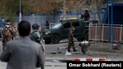 Afghan security forces inspect the site of a blast in Kabul on November 12.