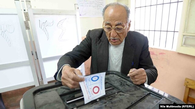 An Egyptian man takes part in the two days of referendum voting on the new constitutional draft in Cairo on January 14.