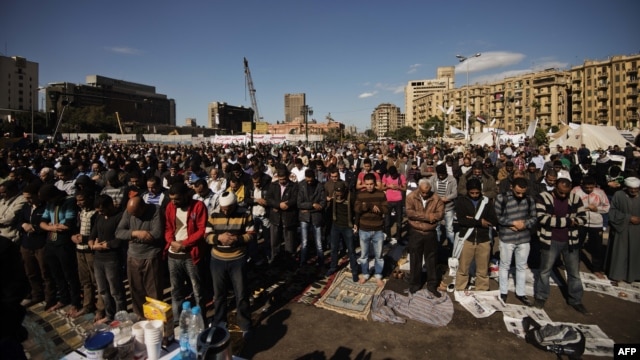 Protesters perform the Friday midday prayer on Cairo's landmark Tahrir Square.