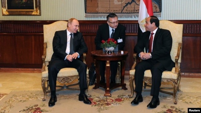Egypt's President Abdel Fattah Al-Sisi (right) talks to Russian President Vladimir Putin (left) during their meeting at Cairo International Airport on February 9.