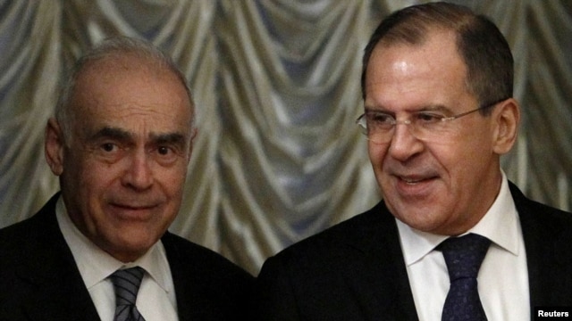 Egyptian Foreign Minister Muhammad Amr (left) and Russian Foreign Minister Sergei Lavrov arrive for a bilateral meeting in Moscow on December 28.