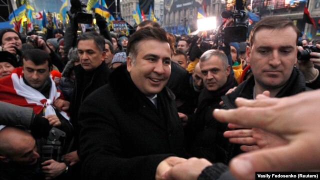 Former Georgian President Mikheil Saakashvili (center) meets pro-European integration protesters on Independence square in Kyiv on December 7.