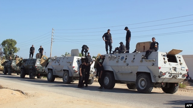 Egyptian security forces stand by their armored personnel carriers ahead of a military operation in the northern Sinai Peninsula on August 8.