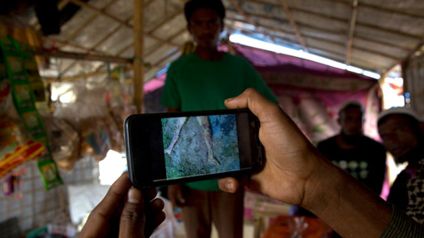 Refugee Mohammad Karim shows his cellphone video of mass grave he found in Myanmar before he fled to Bangladesh, Jan. 14, 2018.