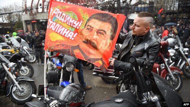 A Russian biker shows a banner depicting Josef Stalin and a World War II slogan 'For the Motherland! For Stalin!' in Moscow last month.