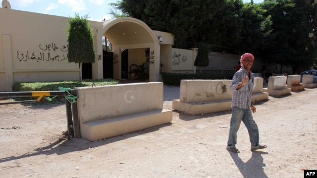 A Benghazi resident walks past the U.S. Consulate in the eastern Libyan city weeks after the deadly attack of September 11, 2012.