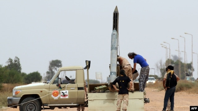 Forces loyal to Libya's UN-backed unity government prepare a missile launcher during clashes with Islamic State (IS) militants west of Sirte earlier this month.  Libyan forces began the battle to retake the city from IS in May.