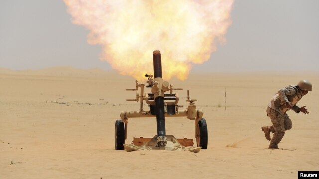 A Saudi soldier fires a mortar toward Huthi positions at the Saudi border with Yemen on April 21.