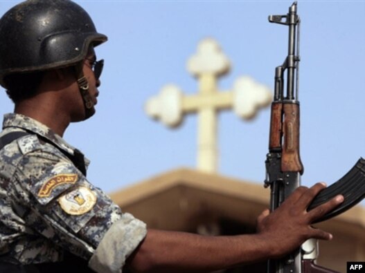 An Iraqi policeman stands guard outside a church in the Baghdad district of Dora. Up to half of Iraq's Christians have fled the country since 2003.