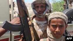 Forces loyal to Yemeni President Abu-Rabbu Mansur Hadi display their arms as they take part in an operation to drive Al-Qaeda fighters out of the capital of southern Abyan Province earlier this year.