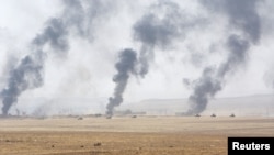 Smoke rises from clashes with Islamic State militants southeast of Mosul in August.
