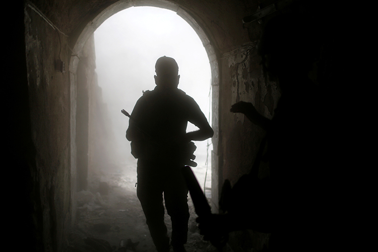 An Iraqi soldier looks for cover after a grenade explosion in the old city of Mosul, July 4, 2017. (Reuters/Ahmed Jadallah)