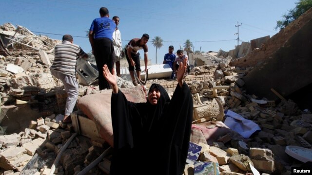 A woman reacts at the site of a suicide bomb attack on a Shi'ite mosque in Mussayab on September 30.