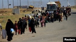 Displaced people flee fighting in Mosul.