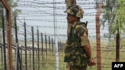 An Indian Border Security Force soldier keeps guard at an Indian-Pakistani border post in Kashmir.