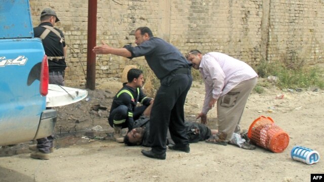 Rescuers help a victim following a mortar attack on the western city of Ramadi, the provincial capital of Anbar province on April 15. 