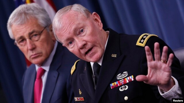 U.S. Chairman of the Joint Chiefs of Staff General Martin Dempsey (right) speaks next to U.S. Secretary of Defense Chuck Hagel during a media briefing at the Pentagon in Washington on July 3.