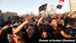 People gather during a protest near the government office in Basra on September 6.