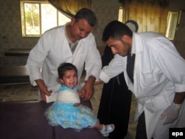 Iraqi doctors treat a child wounded by a roadside bomb.